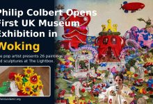 Philip Colbert standing in front of The Lost Gardens of Lobsteropolis at The Lightbox in Woking